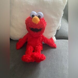 TICKLE ME ELMO. Gently Used. He moves his feet and talks. Please see my video.